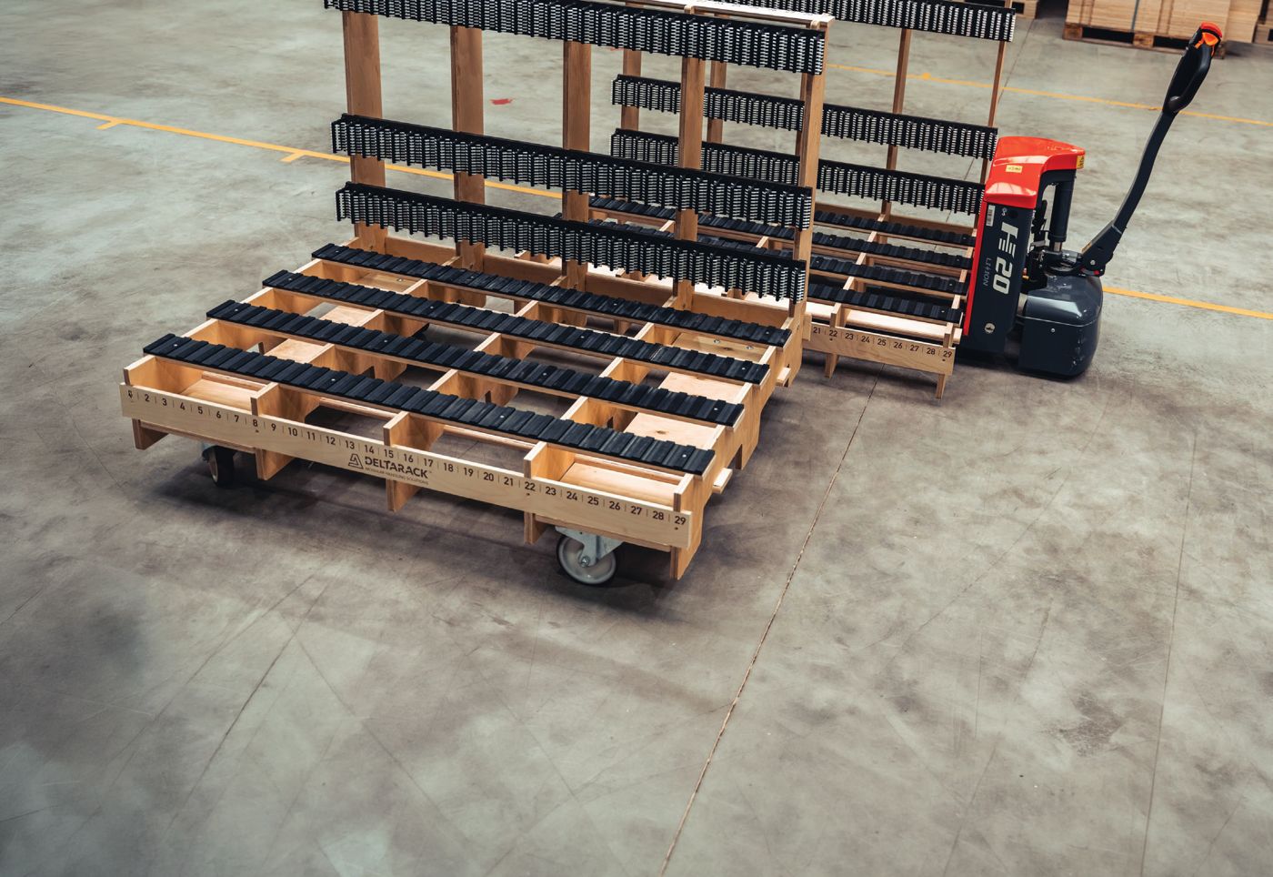 A pallet jack moving a loaded Deltarack glass rack